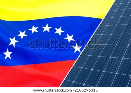 Solar panels against flag Venezuela background. Solar battery generates a pure electricity. Concept of sustainable resources and renewable energy in Venezuela