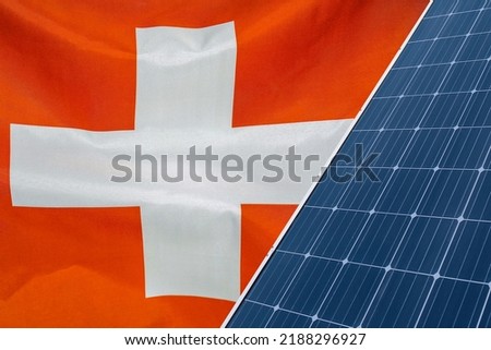 Solar panels against flag Switzerland background. Solar battery generates a pure electricity. Concept of sustainable resources and renewable energy in Swiss