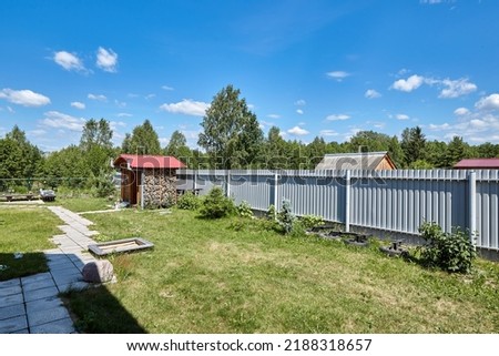 Old rural wooden house in russian village at summer sunny day