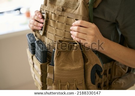 Woman is wearing a protective body armor and hiking kit Royalty-Free Stock Photo #2188330147