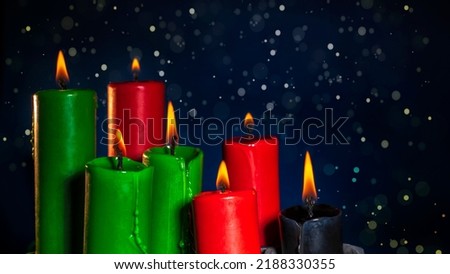 Happy kwanzaa concept with black, red and green candles on dark background, selective focus