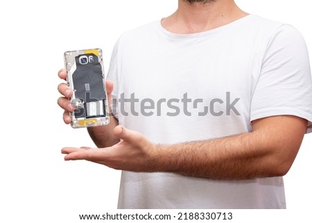 Unrecognizable man on white isolated background showing back side of broken phone in hand