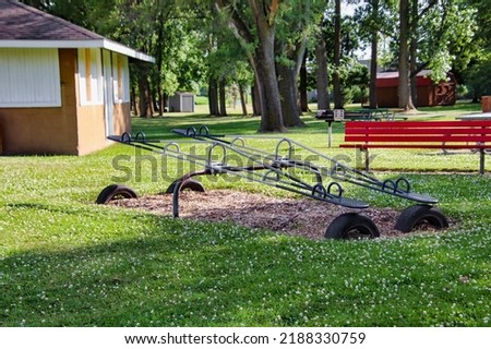 A pair of teeter totters at a community park playground.