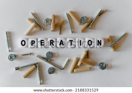Construction business concept. On a white background, building fittings and white cubes with the inscription - operation