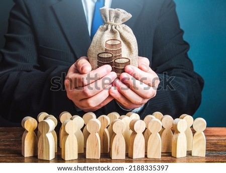 Businessman holds out a money bag to the crowd. Official. Staff maintenance. Tax collection. Compensation payments. Share profit. Providing money, paying salaries and grants. Financial support. Royalty-Free Stock Photo #2188335397