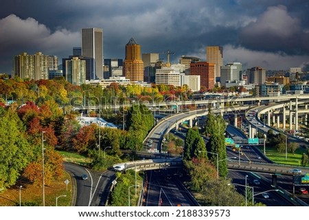 Downtown city of Portland with fall color trees and a freeway interchange in foreground