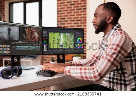 Graphic artist editing film footage on software, using visual effects and color grading to edit movie for post production content. Creating video montage with professional digital app.