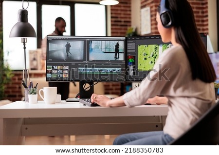 Creative digital editor editing movie footage at home, using professional effects software. Content creator working on multimedia montage with app and audio, post production film.