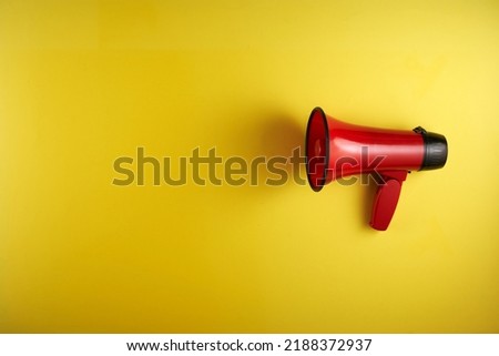 megaphone against yellow background with copy space              