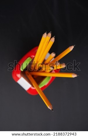 yellow pencil in the pencil holder against chalkboard                      