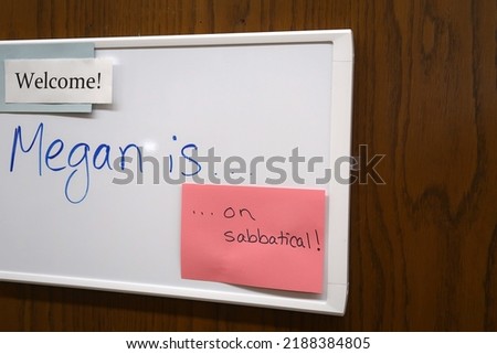 Sign on an office door. Megan is on sabbatical. White board message with index card