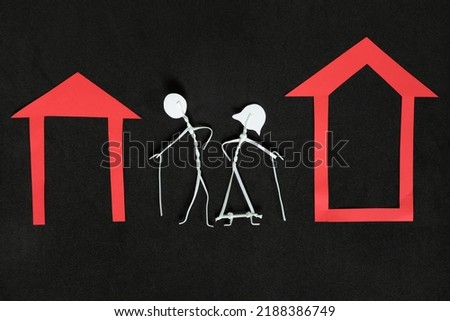 Homeless seniors, retirement home or abandoned old people concept. Elderly couple stick figure in dark black background creative composition.