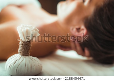Kizhi massage or herbal bolus bags Ayurveda massage, hands of an Ayurveda Massage therapist pressing herbal bolus bags onto client’s skin Royalty-Free Stock Photo #2188404471