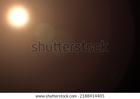 Realistic lens flare in black background. Lens Flare ,Sun Flare on black background. Optical Flare effect illustration. lens effects for overlay designs or screen blending mode. Abstract sun burst Royalty-Free Stock Photo #2188414405
