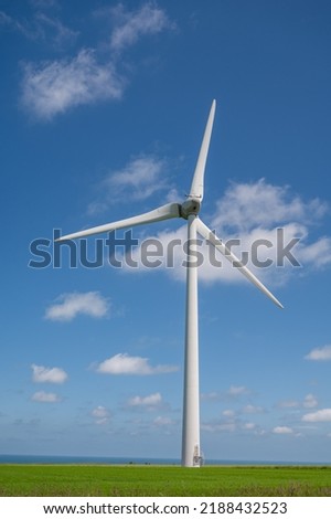 View on modern wind mills, green grain fields and blue Atlantic ocean in agricultural region Pays de Caux in Normandy, France in summer Royalty-Free Stock Photo #2188432523
