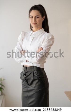 Portrait of young confident successful and beautiful business woman in a modern office. Occupation, career, work concept. copy space.