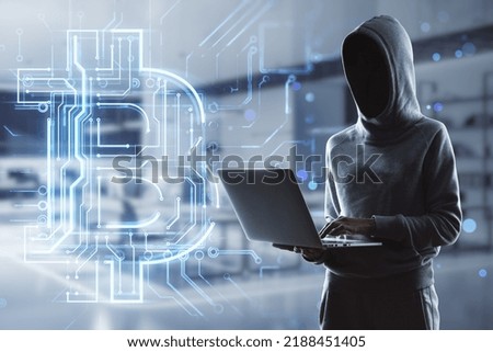 Hacker holding laptop with creative glowing bitcoin circuit hologram on blurry office interior background. Cryptocurrency, blockchain and finance concept. Double exposure