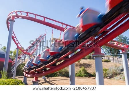 a high-speed ride. A carnival. a roller coaster. A thrilling ride. An amusement park Royalty-Free Stock Photo #2188457907