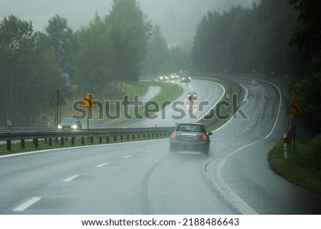 Cars on the autobahn on the rainy day 