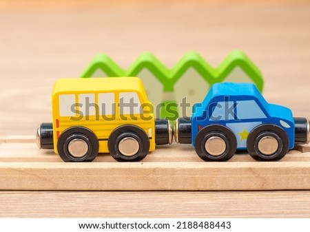 eco wooden toy train tracks for toddlers with cars arranged chaotic on laminate floor.activities for baby,kids.intelligent building blocks.train railway set.police car,autobus.direction sign,left turn