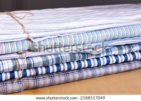 haberdasher fabric shop, choice of textile material in fabric market. Rolls of fabric and textiles in a factory shop or store or bazar. Multi different colors and patterns Royalty-Free Stock Photo #2188517049