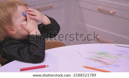 Adorable Caucasian Toddler Baby Girl Drawing Abstract Shapes Picture With Pencil Crayons Making Funny Faces