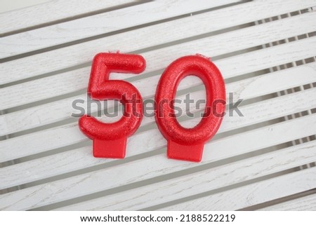 red numbers candles in the cake 50