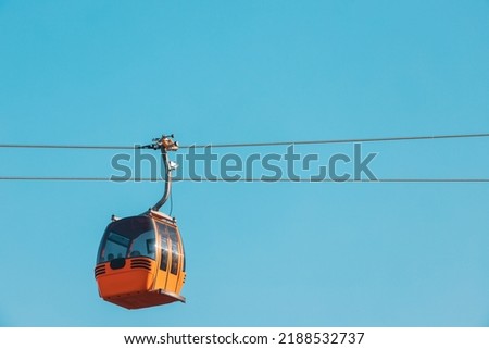 The cab or gondola of the cable car transports tourists and skiers to the mountain