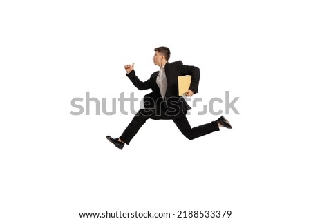 In a hurry. Creative portrait of young office worker in business suit running isolated over white background. Finance, aspiration, business, job concept. copyspace for ad Royalty-Free Stock Photo #2188533379