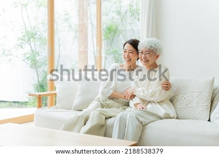 Smiling Asian mother and daughter