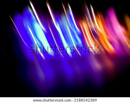 Blurry light painting abstract art texture on a black background. 