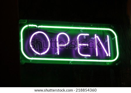 An open sign in the window of a retail establishment