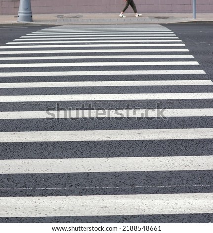 White stripes on the asphalt road. Crosswalk