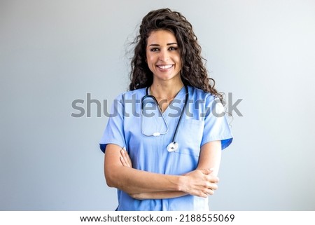 Portrait of a young nurse - doctor. Smiling Argentinian female nurse in medical scrubs. Shot of a female nurse standing confidently with her arms crossed. Portrait of female nurse at hospital
