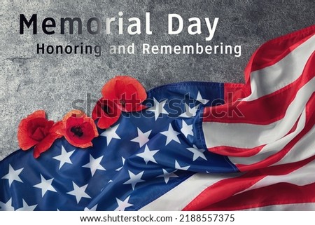 Memorial Day, Honoring and Remembering. American flag and red poppy flowers on grey background, top view