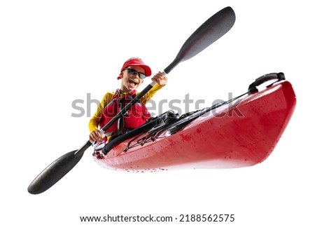 Rowing. Beginner kayaker in red canoe, kayak with a life vest and a paddle isolated on white background. Concept of sport, nature, travel, active lifestyle. Copy space for ad, text, design Royalty-Free Stock Photo #2188562575