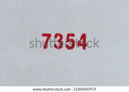 Red Number 7354 on the white wall. Spray paint.
