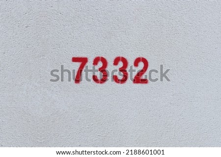 Red Number 7332 on the white wall. Spray paint.

