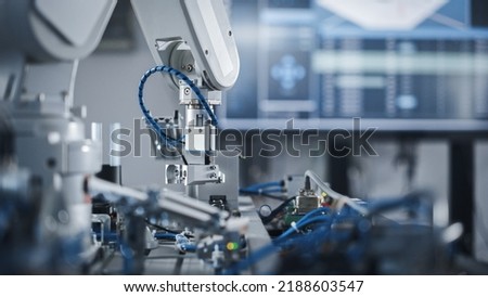 Robotics Industry Four Engineering Facility Robot Arm Moving at Different Directions. High Tech Industrial Technology Using Modern Machine Learning. Mass Production Automatics. Close Up Royalty-Free Stock Photo #2188603547