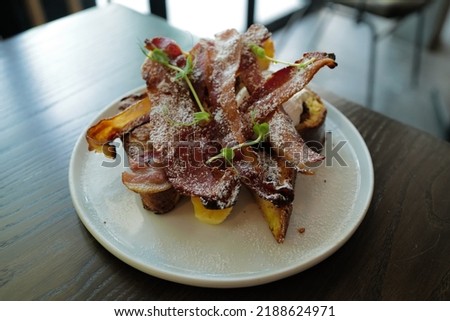 Close up French toast with crispy bacon