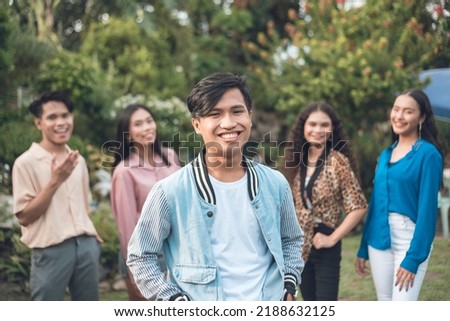 A hip and popular asian guy with four of his teammates or friends. Upbeat mood. Outdoor scene. Royalty-Free Stock Photo #2188632125