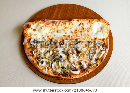 Delicious mixed pizza with rich content. Menu concept of choice and diversity