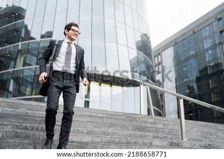 A businessman man goes to work in the office, in a business suit with a briefcase