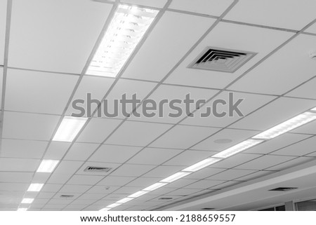 Office room ceiling with lighting. Suspended ceiling with LED square lamps in the office. interior decoration concept Royalty-Free Stock Photo #2188659557