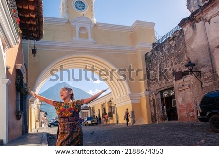 Portrait of a happy indigenous girl with her typical costume in a colonial city. Royalty-Free Stock Photo #2188674353