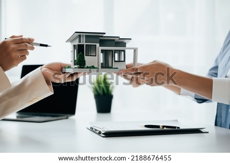 Close up of business's hands selling and signing agreement paperwork for loan financial to buying the house properties.