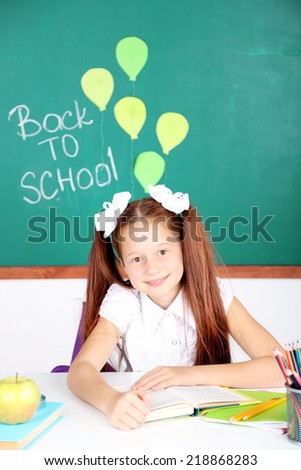 Cute girl at workplace in classroom