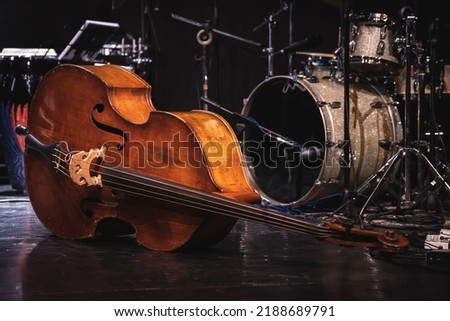 Acoustic double bass on stage with drums on background during a jazz concert Royalty-Free Stock Photo #2188689791