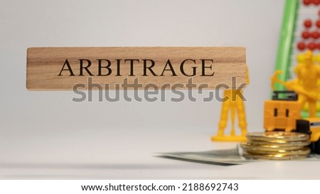 arbitrage sentence written on wooden surface. Economy and concept Royalty-Free Stock Photo #2188692743