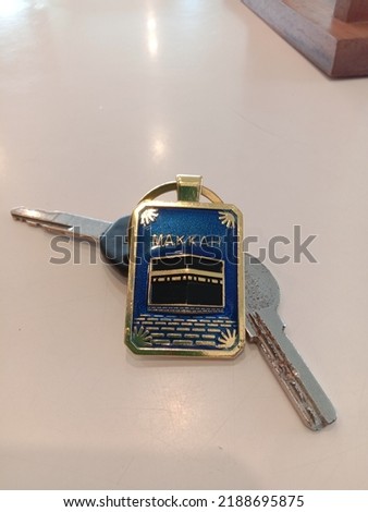 motorcycle keys and house keys with key chains with pictures of the kaaba, mecca